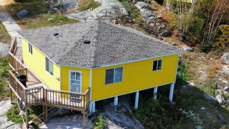 A hexagon cabin on a rock cliff's edge of the lake-best views from the inside of this cabin.