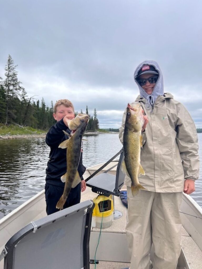 Fun walleye fishing as 2 fisherman are each holding their own fish!!